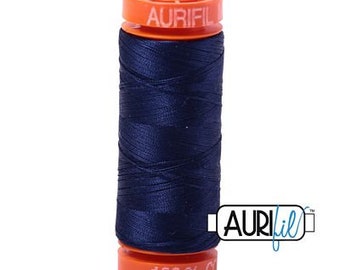 May include: A spool of dark blue thread with a bright orange label that reads "Aurifil" and "100% Cotton".