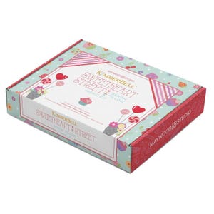 May include: A rectangular box with a colorful design. The box features the text "Sweetheart Street Bench Pillow Fabric Kit" with heart and lollipop illustrations. The box has a red and teal color scheme with floral and dessert-themed patterns.