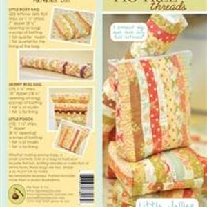 May include: A set of four zippered pouches in various sizes and patterns. The pouches are made of fabric with a patchwork design in shades of brown, orange, yellow, and white. The pouches are stacked on top of each other, with the largest pouch on the bottom and the smallest pouch on top. The pouches are labeled "Little Jellions" and "Fig Tree Threads".