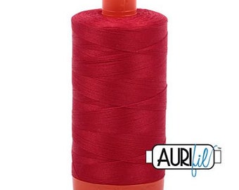 May include: A spool of red thread with a white label that says "AURIfil" in blue lettering.