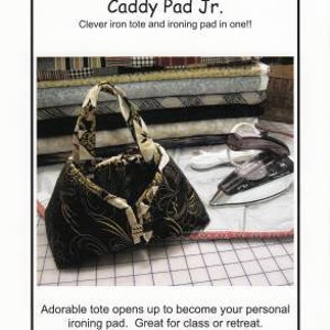 May include: A black and gold patterned tote bag with a handle, next to a white and silver iron. The text on the image reads "Caddy Pad Jr." and "Sisters' Common Thread". The tote is sized to hold a 6"-8" travel iron.