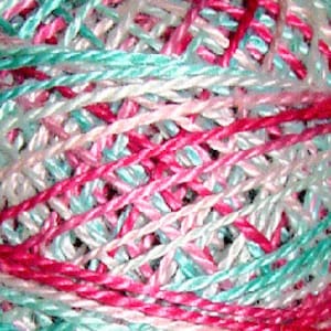 May include: A skein of yarn in shades of pink, teal, and white. The yarn is twisted together in a multi-colored pattern.