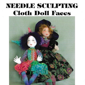 Puede incluir: Un libro titulado "Needle Sculpting Cloth Doll Faces" de Virginia Robertson, Robertsons' Enterprises. La portada presenta dos muñecas de tela, una con un traje de bufón y la otra con un vestido negro y verde con un sombrero morado.