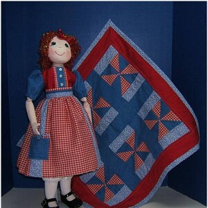 May include: A red and white gingham dress with a blue denim pocket and a blue and red patchwork quilt with a pinwheel design.