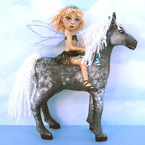 May include: A fairy doll with blonde hair and blue wings riding a grey horse with a white mane and tail.