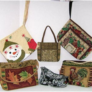 May include: A collection of six different tapestry bags with various designs. The bags are made of a woven fabric with a variety of colors and patterns. The bags are all different sizes and shapes, and they are all hanging from hooks.