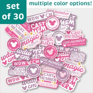 May include: A collection of 30 stickers in various shades of pink and purple, featuring text like "Cast Member" and "Walt Disney World," along with Mickey Mouse silhouettes. The stickers have different shapes and sizes.