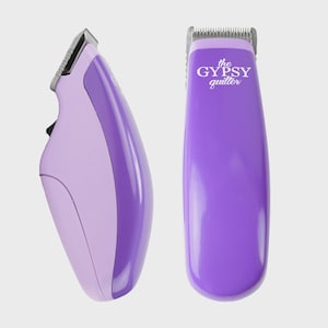 May include: Two cordless hair clippers in shades of purple. The clipper on the left is light purple with a darker purple accent. The clipper on the right is solid purple with the text "the GYPSY quilter" in white.