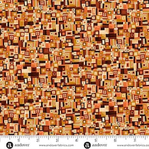 May include: Fabric with a repeating geometric pattern of squares and rectangles in shades of brown, orange, and beige. The design has a retro feel. The fabric is marked with a ruler along the bottom edge.