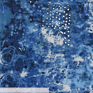 May include: Abstract fabric with a blue and white watercolor design. The pattern features splatters, dots, and swirling lines in shades of blue, with white and gray accents. The fabric has a textured appearance.