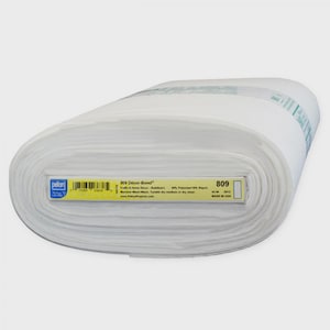 May include: A roll of white fabric labeled "809 Decor-Bond" with text and a barcode. The fabric is 45 inches wide and made in the USA. The roll is tightly wound and appears to be new.