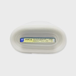 May include: A roll of white fabric with a blue and white label. The label reads "Crafts & Home Decor Interfacing - Stabilizer" and "FF78F1 Flex Foam". The fabric is tightly rolled and appears to be a stabilizer for crafts and home decor projects.