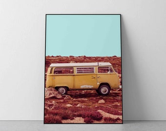 May include: A yellow vintage van parked on a field of red and brown brush. The sky is a light blue.
