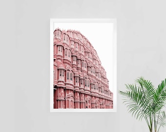 May include: A framed photograph of a pink building with intricate details and many windows. The building is set against a white background.