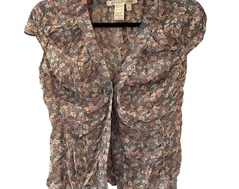 Blusa de seda con estampado floral, botones, mangas cortas y escote en V.