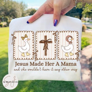 Faith-based “Jesus Made Her a Mama” PNG featuring cute coquette geese and a wooden cross with leopard print bows, perfect for Christian moms.