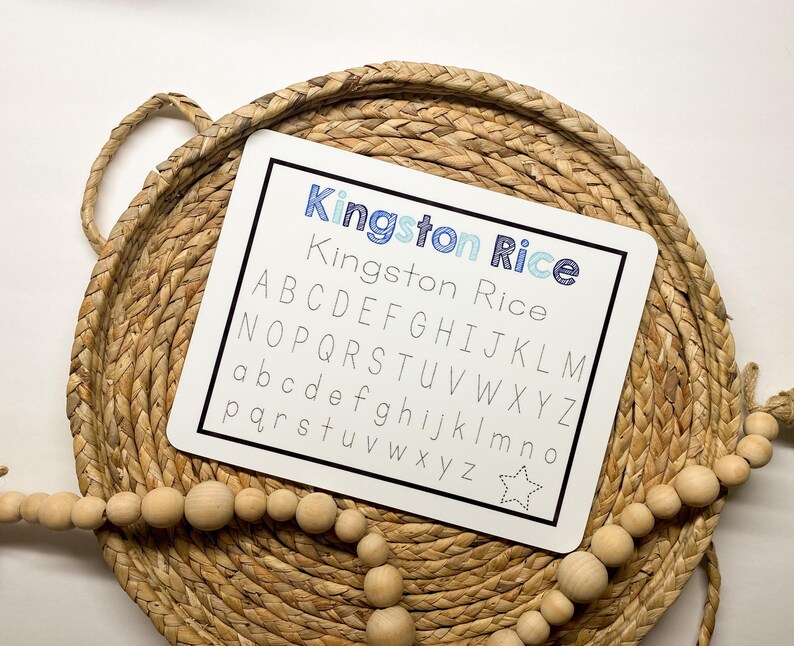 May include: White dry-erase board with the text "Kingston Rice" and the alphabet written in uppercase and lowercase letters. A star is in the bottom right corner.