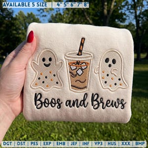 May include: A cream-colored fabric featuring an embroidered design of two ghosts flanking an iced coffee cup with a striped straw. Below the graphics, the text reads Boos and Brews in black script. The top indicates available sizes 4, 5, 6, 7, 8 inches.