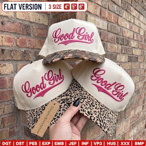 May include: Three off-white baseball caps with leopard print brims and the text Good Girl embroidered in pink. The caps are available in 4, 5, and 6 inch sizes. A brown tag with the text ShopArchersArrow is attached to one of the caps.