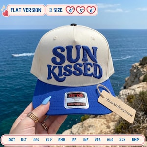 May include: A beige and blue baseball cap with the words "SUN KISSED" embroidered in blue. The cap has a flat brim and a tag that says "ShopArchersArrow". The cap is a 3-size hat, with sizes 4", 5", and 6" indicated.