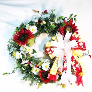 Daisy and sunflower country farmhouse flower front door decor. Rustic summertime white and red porch wreath.