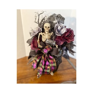 Halloween floral black skeleton table centerpiece, Halloween posable skelly black and purple floral arrangement, black pumpkin decoration.