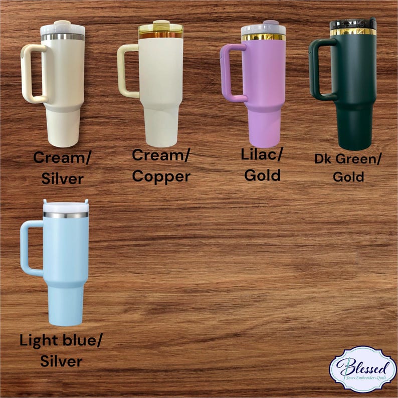 May include: A collection of insulated tumblers in various colors, including cream, lilac, dark green, and light blue. Each tumbler has a handle and a lid. The tumblers are labeled with their color and accent metal, such as silver, gold, and copper.
