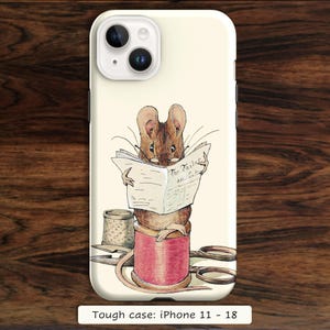 May include: A cream-colored phone case featuring a watercolor illustration of a brown mouse wearing glasses and reading a newspaper titled The Tailor and Cutter. The mouse sits on a large red spool of thread next to a metal thimble and scissors.