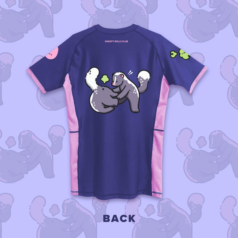 May include: Navy blue athletic shirt with pink accents and a cartoon skunk graphic. The shirt features the text "SWEATY ROLLS CLUB" and "BACK". The skunk graphic shows two skunks hugging. The shirt has short sleeves.