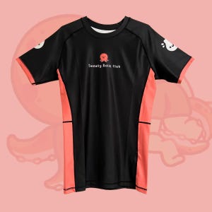 May include: Black athletic t-shirt with coral side panels and sleeve trim. The shirt features a small octopus graphic above the text "Sweaty Rolls Club" on the chest. White cartoon octopus graphics are on the sleeves.