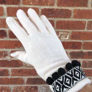 Fleece gloves with decorative trim and screen friendly finger tips.  Please indicate color preference.  One size fits most.