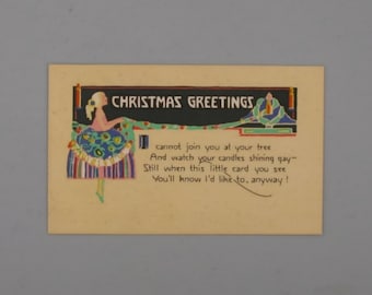May include: A vintage Christmas card with a stylized illustration of a woman in a blue and green dress. The text reads "Christmas Greetings" and includes a poem about not being able to join someone for the holidays.