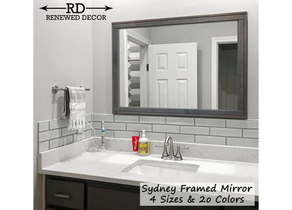 Unframed and understated, this sleek bathroom mirror is perfect for opening up your powder room or another space in your home. etsy