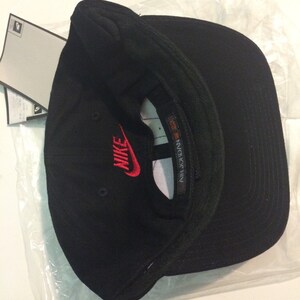 May include: Black baseball cap with a red Nike logo and the text "AIR JORDAN" on the side.