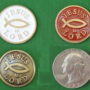 May include: Four religious tokens with the text "JESUS is LORD" and a fish symbol. One token is white with gold trim, another is red with gold trim, and a third is bronze. A US quarter coin from 1982 is also shown.