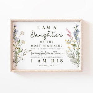 May include: A framed print with a watercolour illustration of wildflowers and the text "I am a Daughter of the Most High King who is not moved by the world for my God is with me and goes before me I do not fear because I am His 2 Corinthians 6:18".