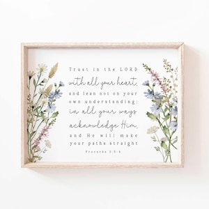 May include: A framed print with the text "Trust in the LORD with all your heart..." from Proverbs 3:5-6. The print is surrounded by watercolor floral arrangements in shades of blue, pink, and green, set against a white background.