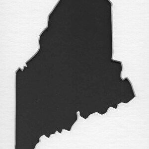 May include: A black silhouette of the state of Maine, cut out of a white background.