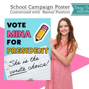May include: A blue and yellow poster with the text "VOTE MINA FOR PRESIDENT" and a cartoon pencil. The poster also has a white sheet of paper with the text "She is the write choice!" written on it. A young woman is holding the poster in front of her.
