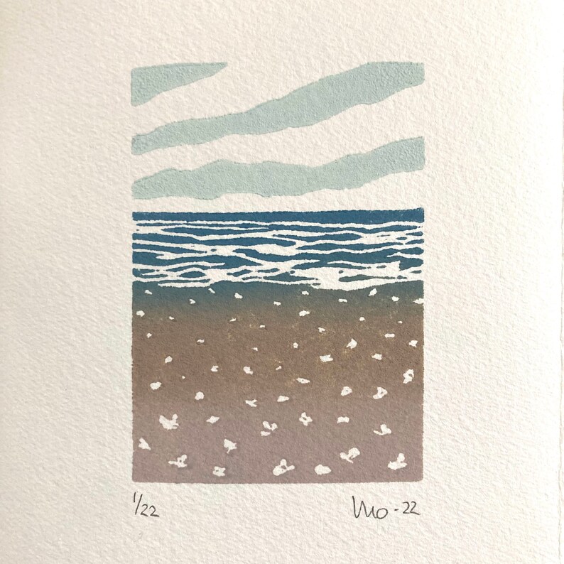 May include: A blue and brown linocut print of a seascape with three horizontal lines of clouds above the water. The print is signed "1/22" and "Mo-22" in the bottom corners.