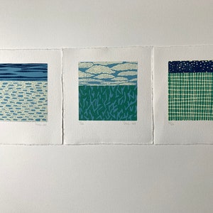 May include: Three framed prints with abstract geometric patterns in shades of blue, green, and white. The prints are titled "Sea", "May", and "June".