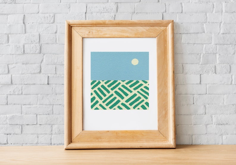 May include: A framed print of an abstract landscape with a light blue sky, a white sun, and a green and yellow patterned field.