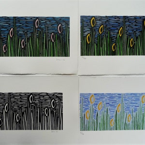 May include: Four different color variations of a woodblock print depicting a field of green grass with yellow and pink flowers against a blue sky.