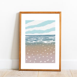 May include: A framed illustration of a seascape with a blue sky, white clouds, blue ocean waves, and a sandy beach with white dots. The frame is made of wood and has a light brown color.