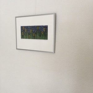May include: A framed print of a landscape with yellow flowers and green grass against a blue sky. The print is titled "Morning Glory" and is signed by the artist.