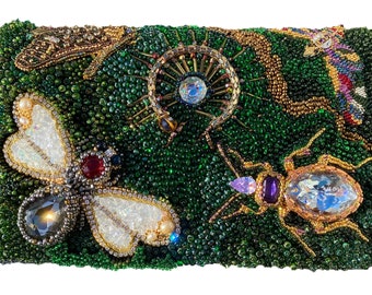 May include: A beaded clutch purse with a green background and a variety of colorful insects and jewels. The insects include a dragonfly, a beetle, and a spider. The jewels are made of glass and are in various colors, including red, blue, and purple.