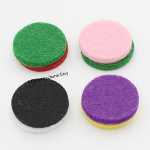 May include: Four round felt pads in different colors. The pads are layered with two different colors. The colors are green and red, pink and green, black and white, and purple and yellow.