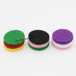 May include: Three sets of round felt pads in different colors. Each set has four pads stacked on top of each other. The colors are green, red, yellow, black, pink, green, purple, white, and pink.