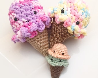 May include: Three crocheted ice cream cones with different colored scoops. The cones are brown and the scoops are pink, purple, yellow, white, peach, and green.
