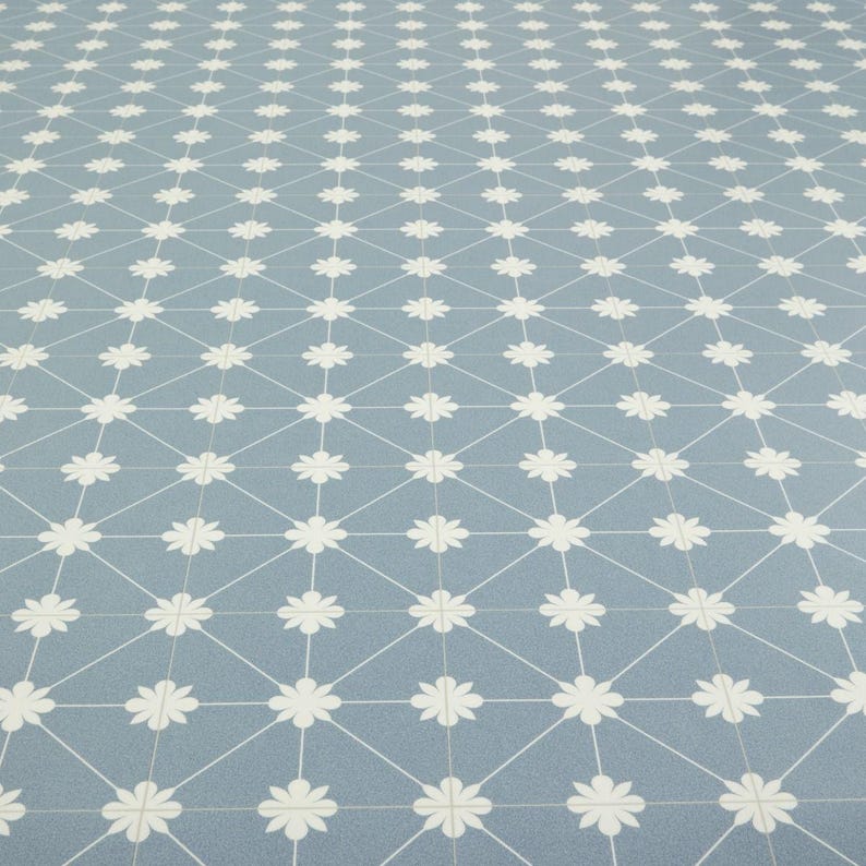 May include: A light blue patterned surface with a repeating floral design. White flowers are arranged in a grid pattern, connected by white lines. The overall effect is a clean, geometric design.